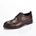 Detailed side view of men's vintage brown leather brogue shoe with intricate carving - 38 / Dark Brown