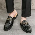 Elegant black croc-patterned men's backless loafers with gold buckle detail. - Black