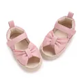 Charming pink infant sandals featuring a large decorative bow and soft breathable sole - Pink