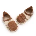 Vue détaillée de chaussures de marche pour bébé tissées marron à semelles souples. - Marron