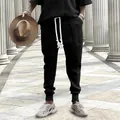 Stylish men's black knitted drawstring pants featuring a unique textured jacquard pattern - S / Bottoms / Black