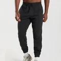 Close-up of men's black joggers showing drawstring waist and knit fabric texture - S / Bottoms / Black