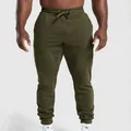 Detailed view of olive green men's athletic joggers with drawstring and cuffed ankles - S / Bottoms / Army Green