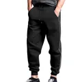 Close-up of black men's joggers featuring iconic double side stripes and elastic cuffs. - S / Bottoms / Black