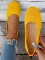 Close-up of yellow mesh flat shoes showing breathable texture and comfortable inner sole design - Yellow