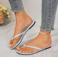 Close-up detail showing light blue flat thong sandals for women in a summer setting. - Blue