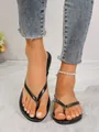 Chic black flat thong sandals for women featuring minimalist straps for summer wear - Black