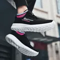 Breathable black fly-knit slip-on sneakers with stylish pink accents for casual running. - 36 / Black Peach Pink