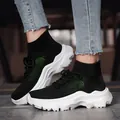Breathable black flyknit high-top sneakers with chunky white sole and green accents - Black and White