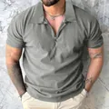 Close-up of men's grey short sleeve zip polo shirt with vertical pleated texture - Medium Grey