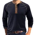 Close-up of a men's navy blue long-sleeve Henley shirt with a retro contrast brown trim. - Sapphire Blue