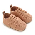 Close-up of peach knit infant flats with breathable mesh and brown leather pull tab - Brown