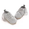 Close-up view of grey knitted infant flat shoes featuring hollow heart pattern and laces - 12cm / Gray