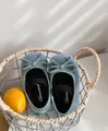 Soft blue suede girl's Mary Jane princess shoes with bow detail shown in a basket - Size 22 (14.5CM) / Mint Green