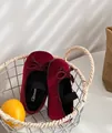 Detailed view of wine red velvet girls' princess shoes with bow accents in a basket - Size 24 (Length 15.5) / Burgundy