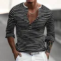 Close-up detail of a men's slim fit long-sleeve striped Henley shirt in piqué fabric. - S / Tops / Black