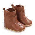 Close-up of brown baby winter boots with floral embroidery and heart toe pattern - Brown
