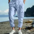 Men's light blue linen cargo jogger pants with side pockets in beach lifestyle setting - S / Bottoms / Light Blue