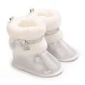 Detail view of silver sparkling baby boots with white faux fur and cute bow decoration - Silver