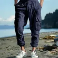 Detail view of men's navy blue cotton linen cargo pants with drawstring and pockets - Navy Blue