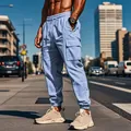 Men's light blue cargo joggers in an urban street setting with large side pockets. - S / Bottoms / Light Blue