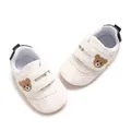 Soft-sole white baby walking shoes featuring cute brown bear embroidery details - Black and White
