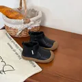 Detailed view of black toddler leather boots with side zipper and durable brown rubber sole - Black