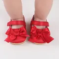 Detail view of red satin infant walking shoes featuring a large decorative bow and strap - Insole Length 11cm / Red