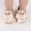 Elegant champagne satin baby walking shoes with a decorative large bow and strap detail - Gold