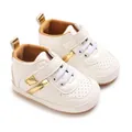 Detailed view of white infant soft sole sneakers with gold accents and velcro straps - Platinum