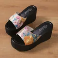 Close-up of women's floral wedge platform slippers with thick black sole on wood. - 36 / Color 3