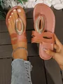 Women's brown flat flip-flop sandals featuring a large silver oval metal ornament - 35 / Brown