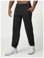 Detailed view of men's black joggers featuring elastic waistband and cuffed ankles. - S / Bottom (DWK1017) / Premium Black