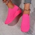 Detail view of hot pink fly-knit slip-on sneakers with breathable mesh texture. - 37 / Rose Red
