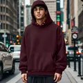 Close-up of a men's burgundy fleece hoodie with kangaroo pocket in an urban city street - Wine Red