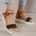 Detailed view of women's platform wedge sandals with black strap and brown buckle. - 35 / Linen Black
