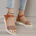 Close-up detail of women's brown wedge sandals with espadrille trim and ankle strap - 35 / Linen Brown