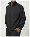 Side view of men's black quarter-zip sweatshirt showing relaxed fit and fabric texture - Premium Black / S