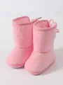 Close-up of soft pink plush baby snow boots with warm lining for infant winter walking - High-top Pink
