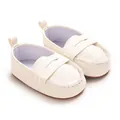 Close-up of white soft-sole baby loafers with textured faux leather finish - White