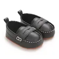 Close-up of black baby leather loafers with white stitching and soft anti-slip soles - Black