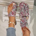 Detail view of paisley floral print flat toe-post sandals for summer beach wear. - Rainbow