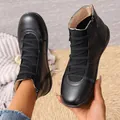 Close-up view of black high-top Martin boots featuring a side zipper and lace-up design - 36 / Black