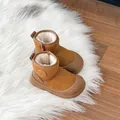 Detailed view of camel children's snow boots with soft plush lining on white fur rug - Brown