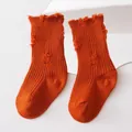 Close-up showing texture of orange distressed mid-calf beggar style socks for kids - M (1-3 Years) / Rust Red