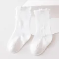 Detailed view of white distressed mid-tube children socks with ruffled cuffs and ribbed knit - M (1-3 Years) / White