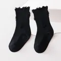 Detailed texture of black distressed mid-calf socks for kids with trendy ripped design - M (1-3 Years) / Black