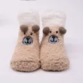 Detailed view of cute plush baby socks with a brown cartoon puppy face design. - 0-1 Years / Eye-Coffee