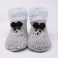 Detailed view of cute plush baby floor socks with cartoon face and pom-poms - Eye-Gray