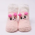 Front detail of cute plush pink and white baby socks with cartoon animal face and pom-poms - 0-1 Years / Eye-Pink